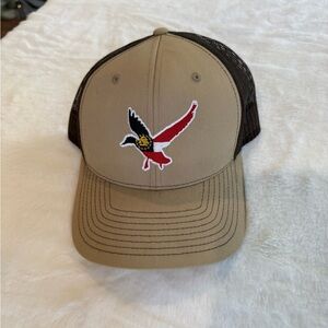 Tan and Black Trucker Hat with Bird Logo